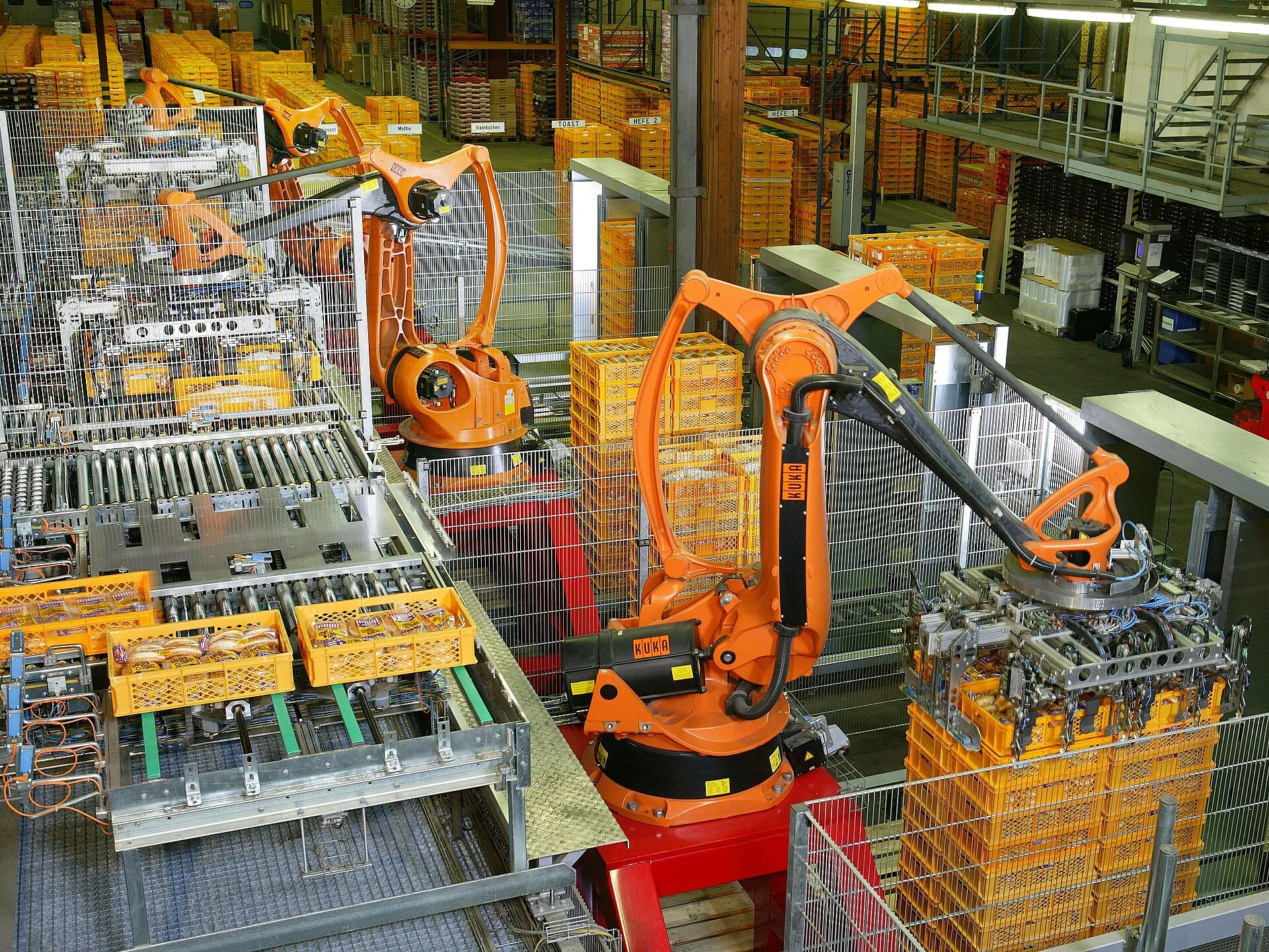 Factory Automation with industrial robots for palletizing food products like bread and toast at a bakery in Germany, robotics